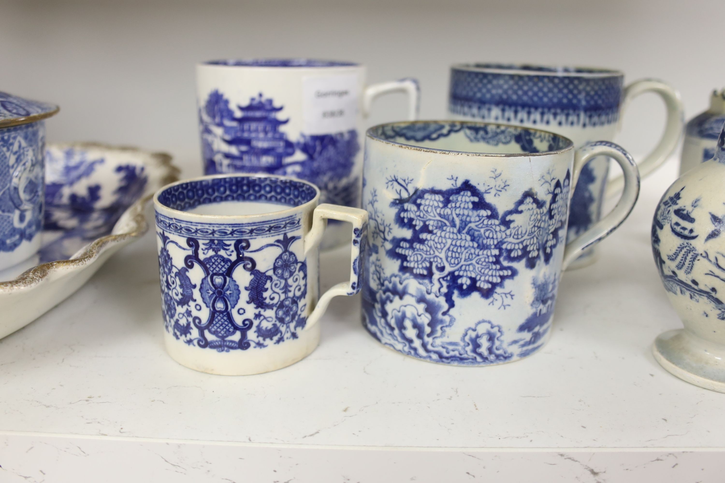 A collection of English blue and white pottery, various dates, comprising a moulded hexagonal teapot and cover, with widow finial, ovoid teapot and cover, lozenge section sugar bowl and cover, with swan finial, circular